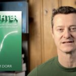 a headshot of Adam Dorr, with his book Brighter: Optimism, Progress, and the Future of Environmentalism 
